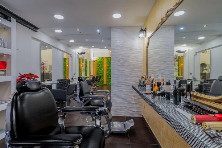 Row of hairdressing chairs and gold-framed mirror at Attilio Secchi Parrucchieri in the centre of Villasimius.