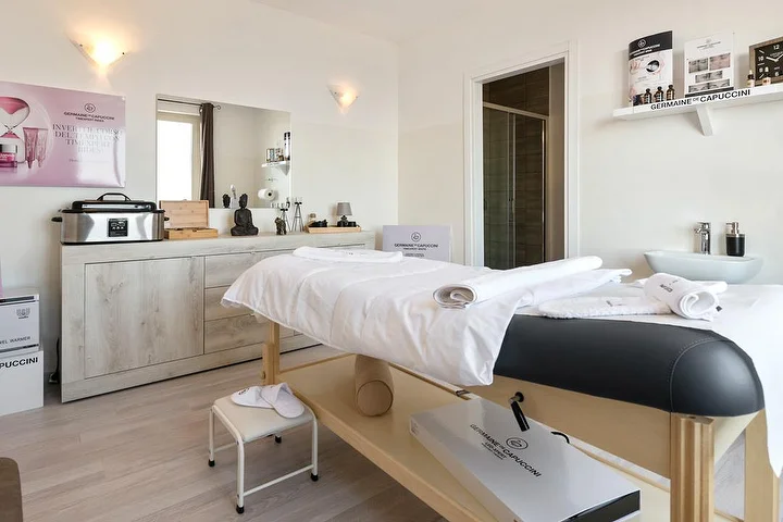 Treatment room at Beauty Time in Lanusei with a massage bed and Germaine de Capuccini skincare products.