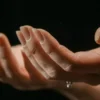 Two hands outstretched with palms up showing flaking nails